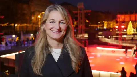 Slavica Olujic Klapcic, one of the organisers of Zagreb Advent, stands in front of the ice rink at night