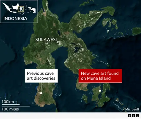Oldest cave art discoveries in Sulawesi, Indonesia
A satellite-style map shows the Indonesian island of Sulawesi and surrounding sea, viewed from above with green land and dark blue ocean. Inset at the top left is a small map of Indonesia with a yellow box highlighting Sulawesi’s location. Large white text labels the main island “Sulawesi.” Near the south‑west of Sulawesi, a white dot and white label read “Previous cave art discoveries.” To the south‑east, on a smaller adjoining landmass, a second white dot is connected to a bold red label that reads “New cave art found on Muna Island.” At the bottom left, a scale bar shows “100 km” above “100 miles.”