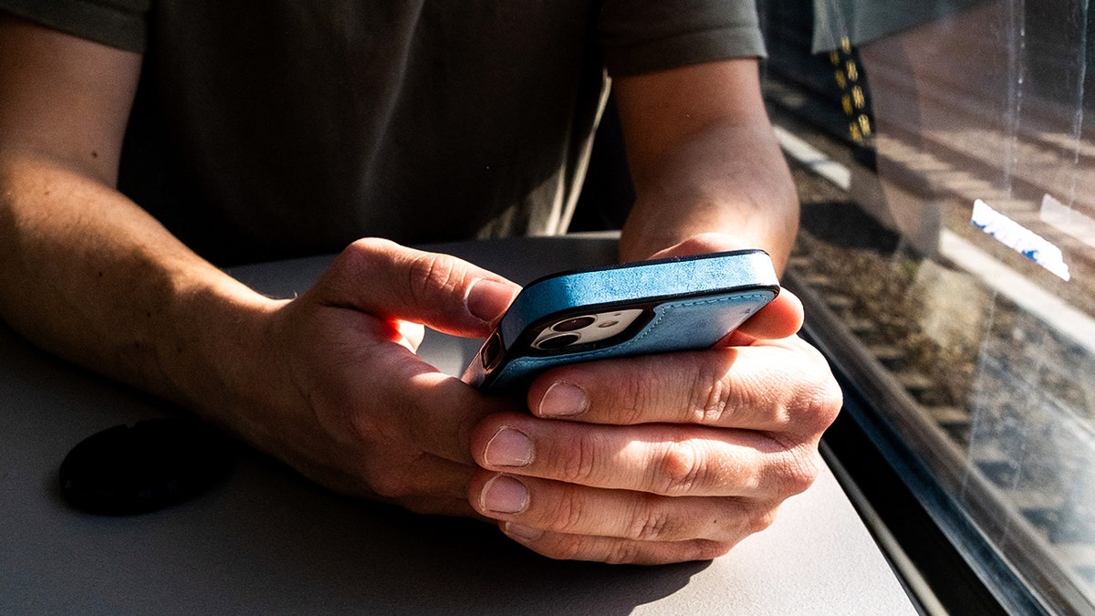 Person typing on their phone.